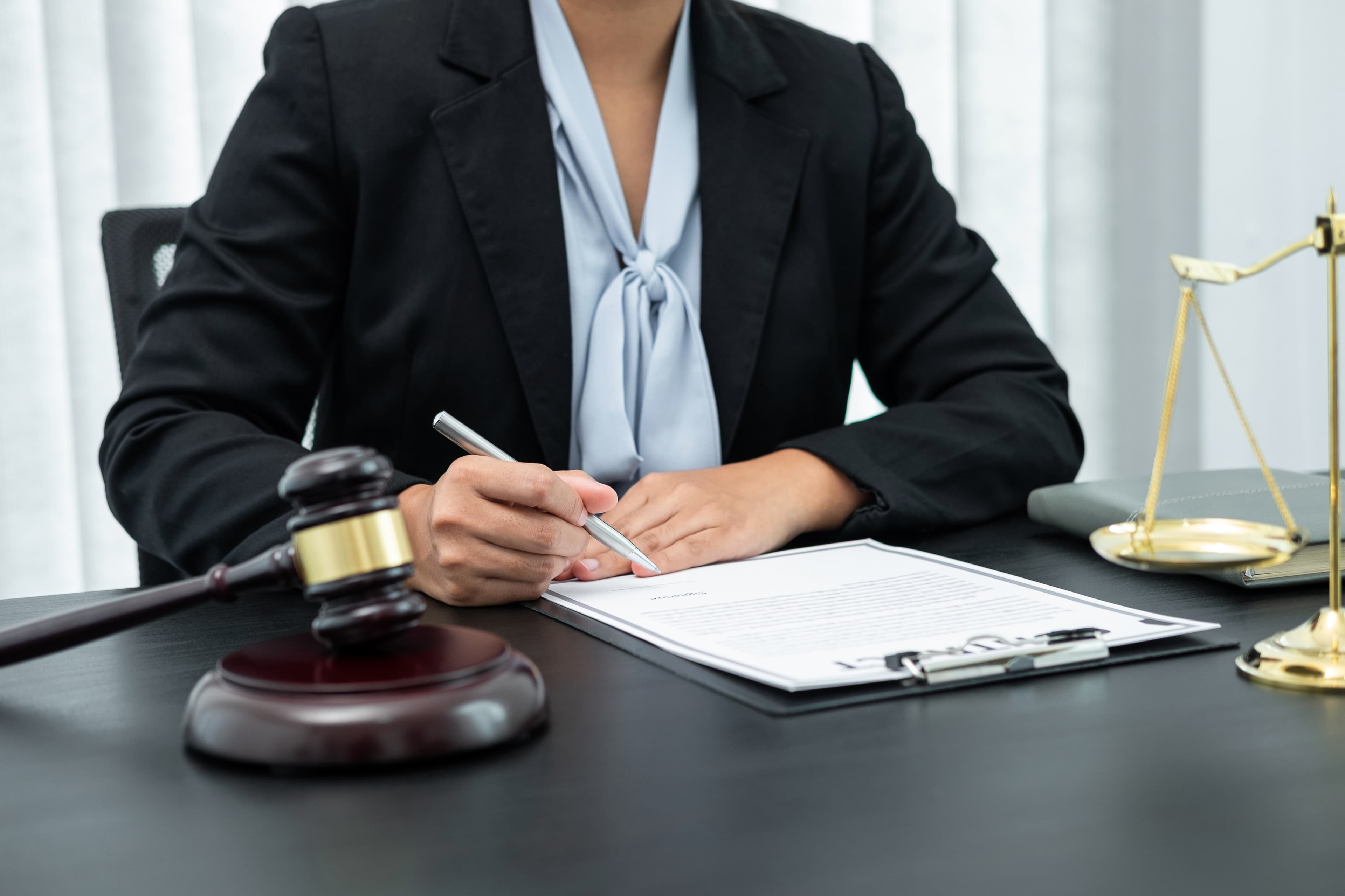 Person reviewing will documents with a solicitor at a desk